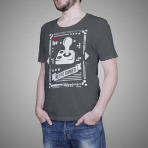 A white joystick on a gray shirt with the text "1UP" and three red hearts in the top left corner, "Retro Gamer" in the center, and the text "The Ablegamers Charity" in the bottom right corner.