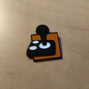 A black joystick with two white buttons on an orange background.